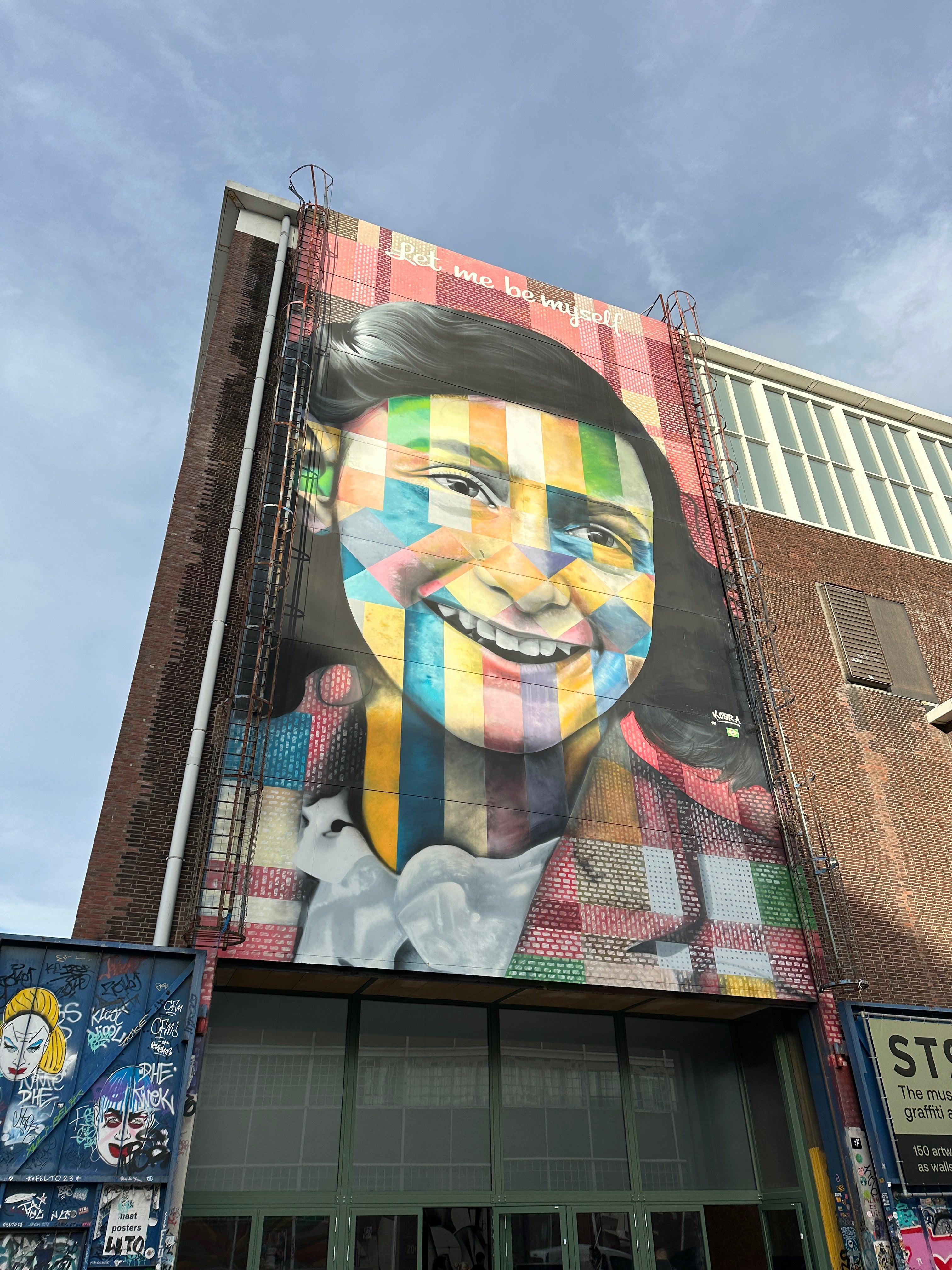 Team exploring Eduardo Kobra’s Anne Frank mural during the Amsterdam Team Building Street Art Walk at NDSM Wharf.