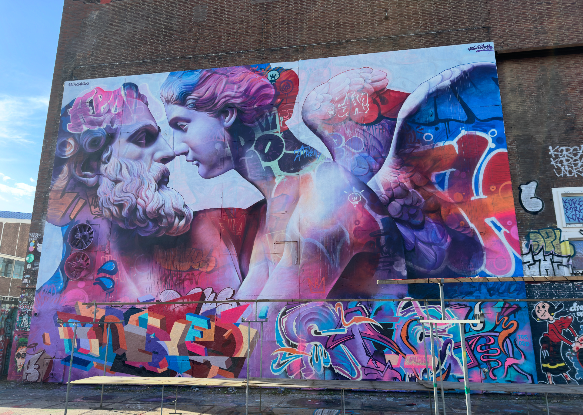 Coworkers exploring graffiti walls and installations at STRAAT Museum during the Amsterdam Team Building Street Art Walk.