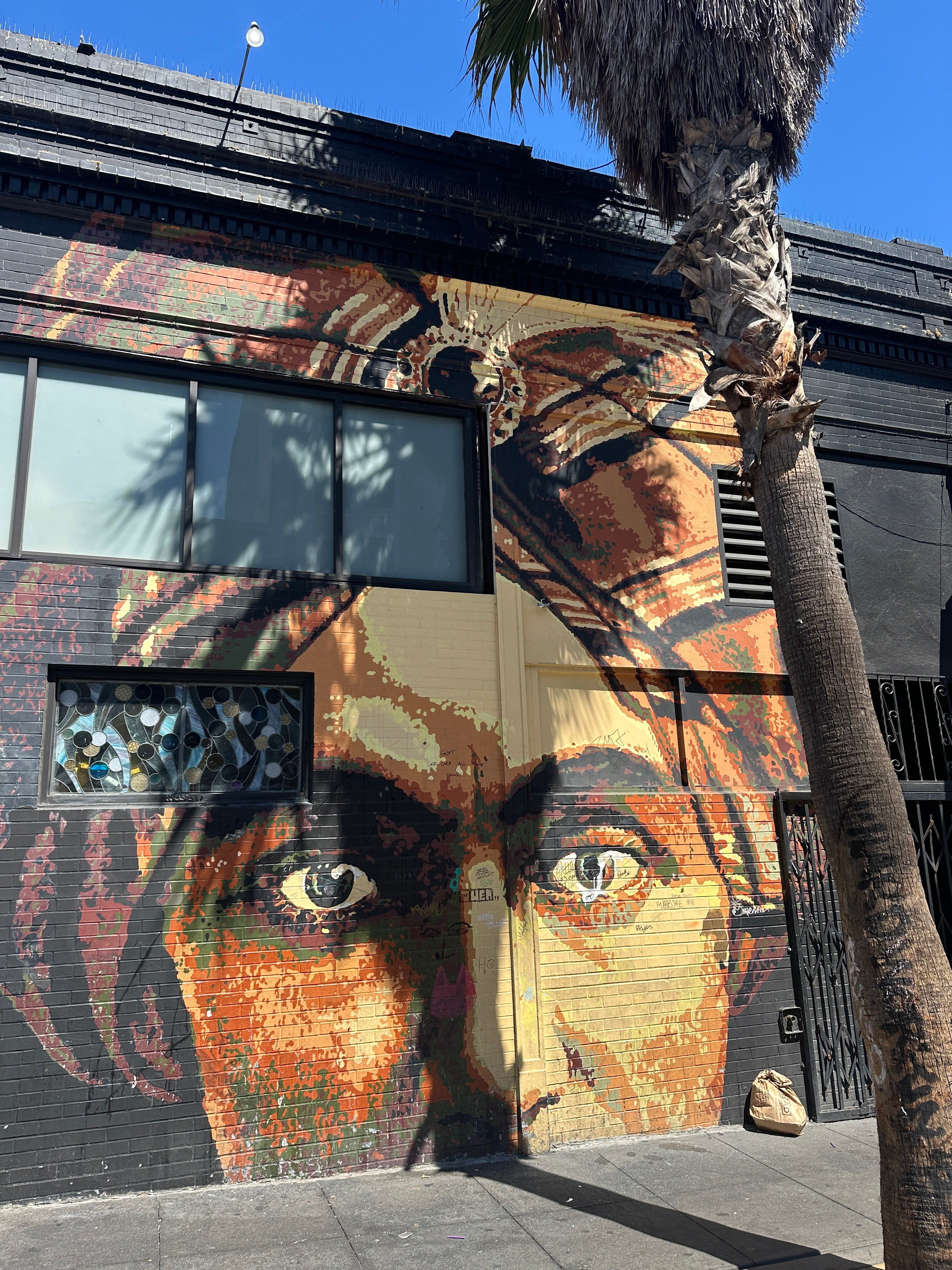 mall group doing a casual graffiti tour San Francisco with bold Mission murals