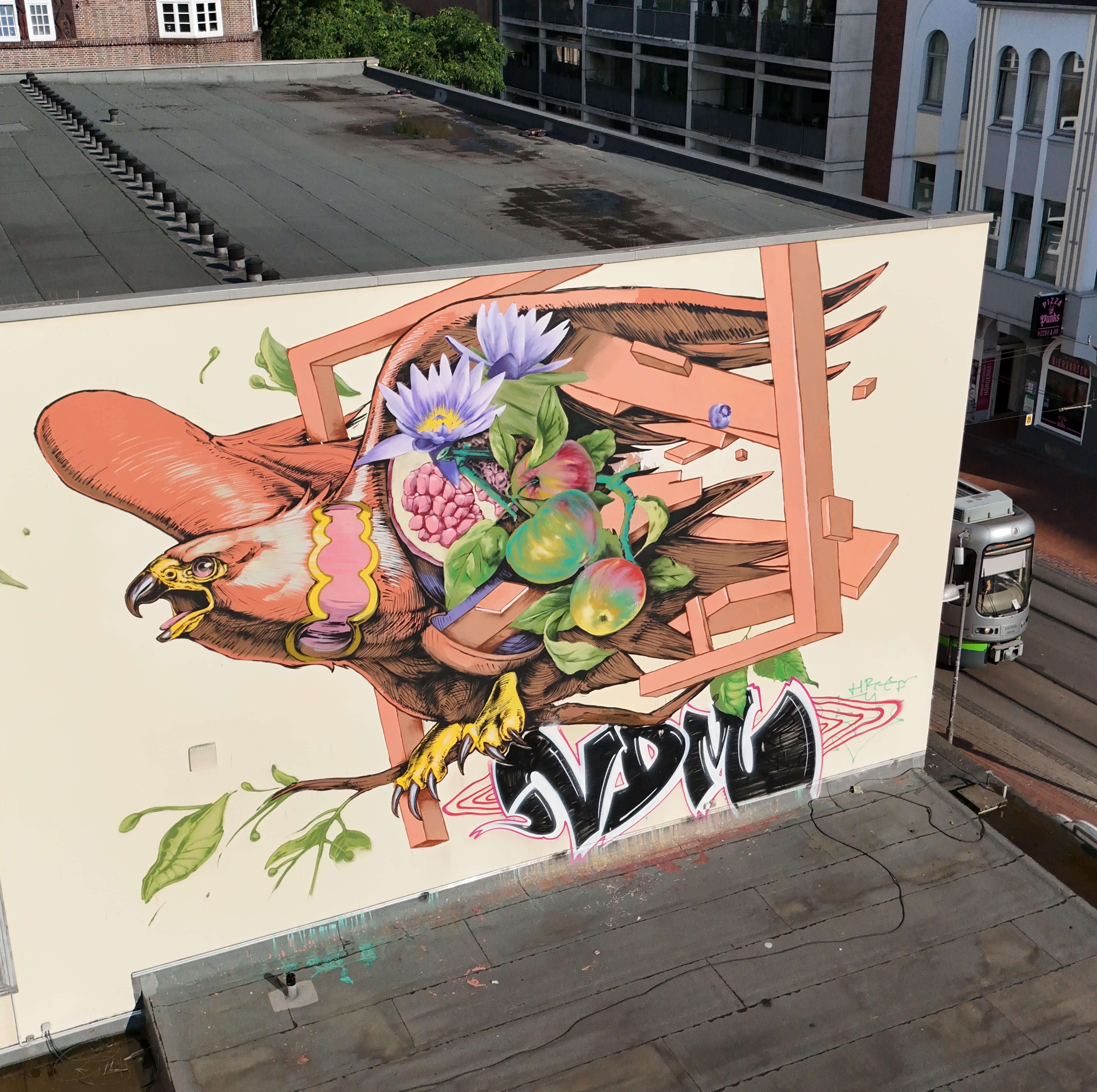 Street Art Tour Hannover featuring the graffiti artwork by Jash and Nasca1, depicting a vibrant urban scene in Hannover.