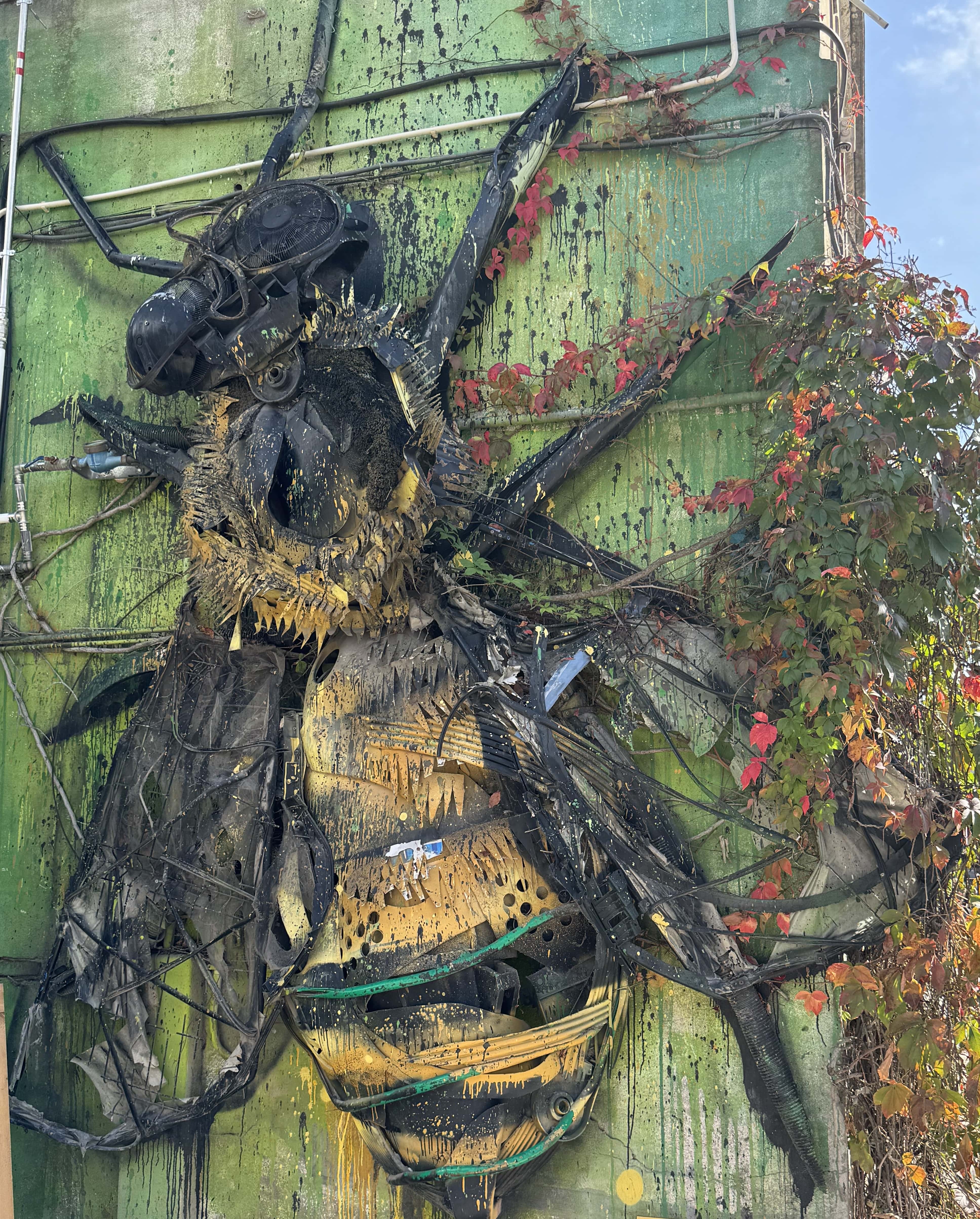 Street Art Tour Lisbon featuring the 3D artwork Bee by Bordalo II, created from recycled plastic materials at the LX Factory in Lisbon.