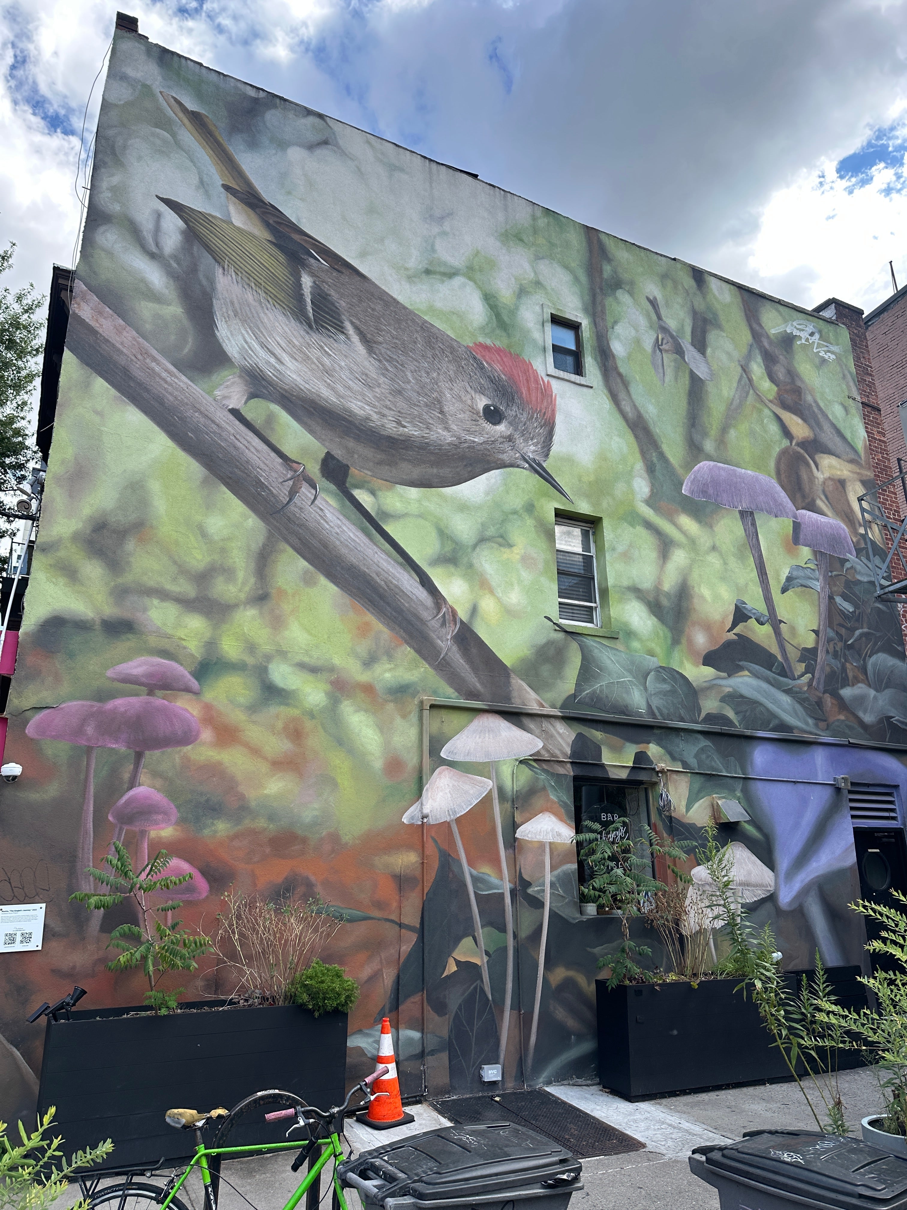 Students on a New York class trip exploring Williamsburg murals, working in teams with the Street Art Game app during a self-guided urban art tour.