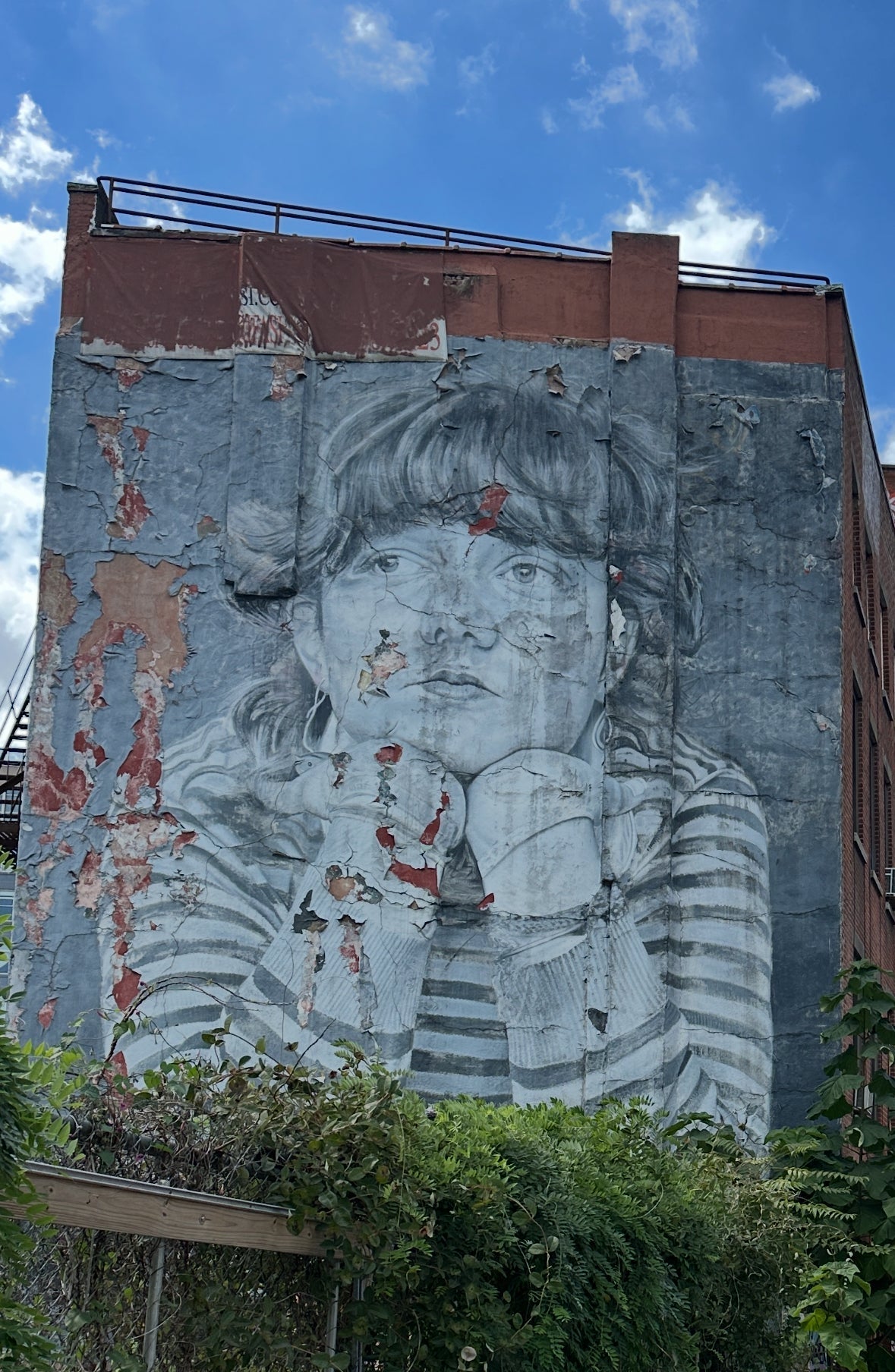 Corporate team exploring Williamsburg street art in Brooklyn, solving app challenges together on a self-guided New York team-building walk.