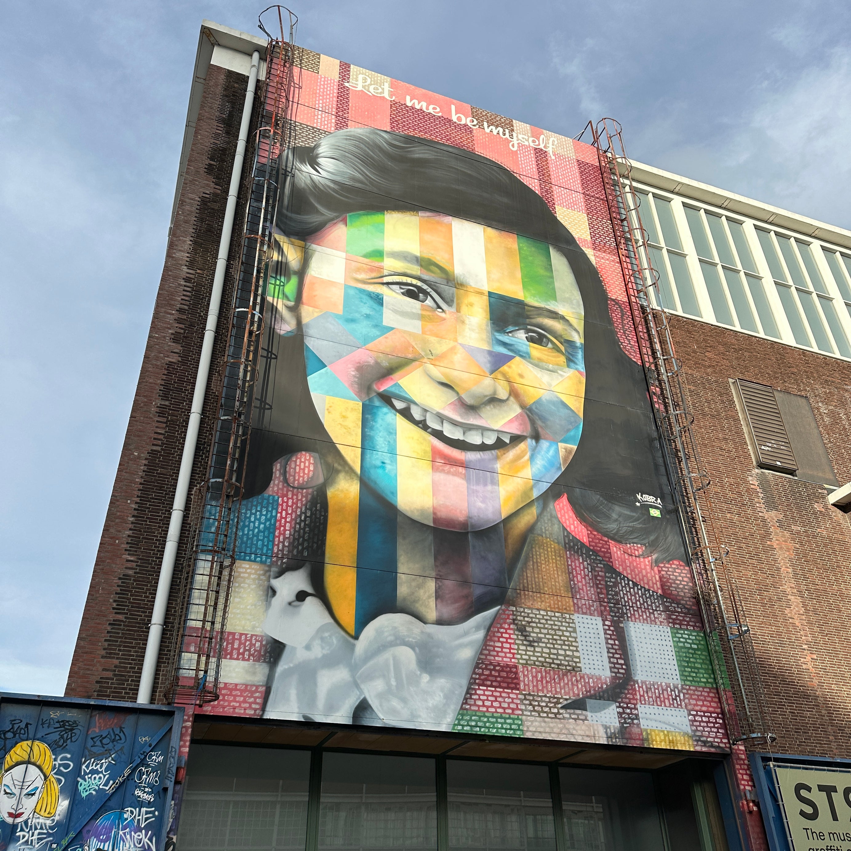 Team exploring Eduardo Kobra’s Anne Frank mural during the Amsterdam Team Building Street Art Walk at NDSM Wharf.