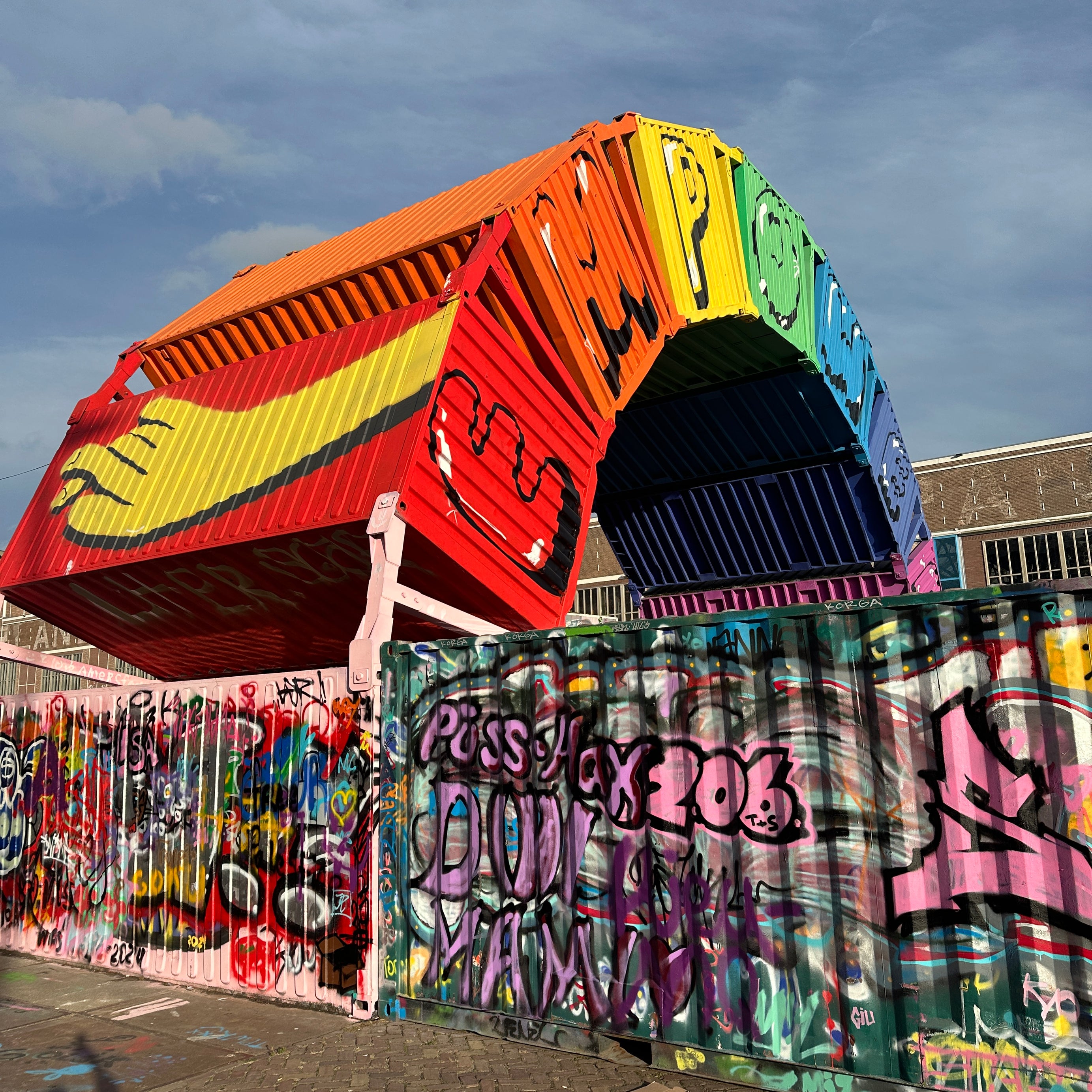 Group checking the live leaderboard beside containers on a City Hunt Amsterdam