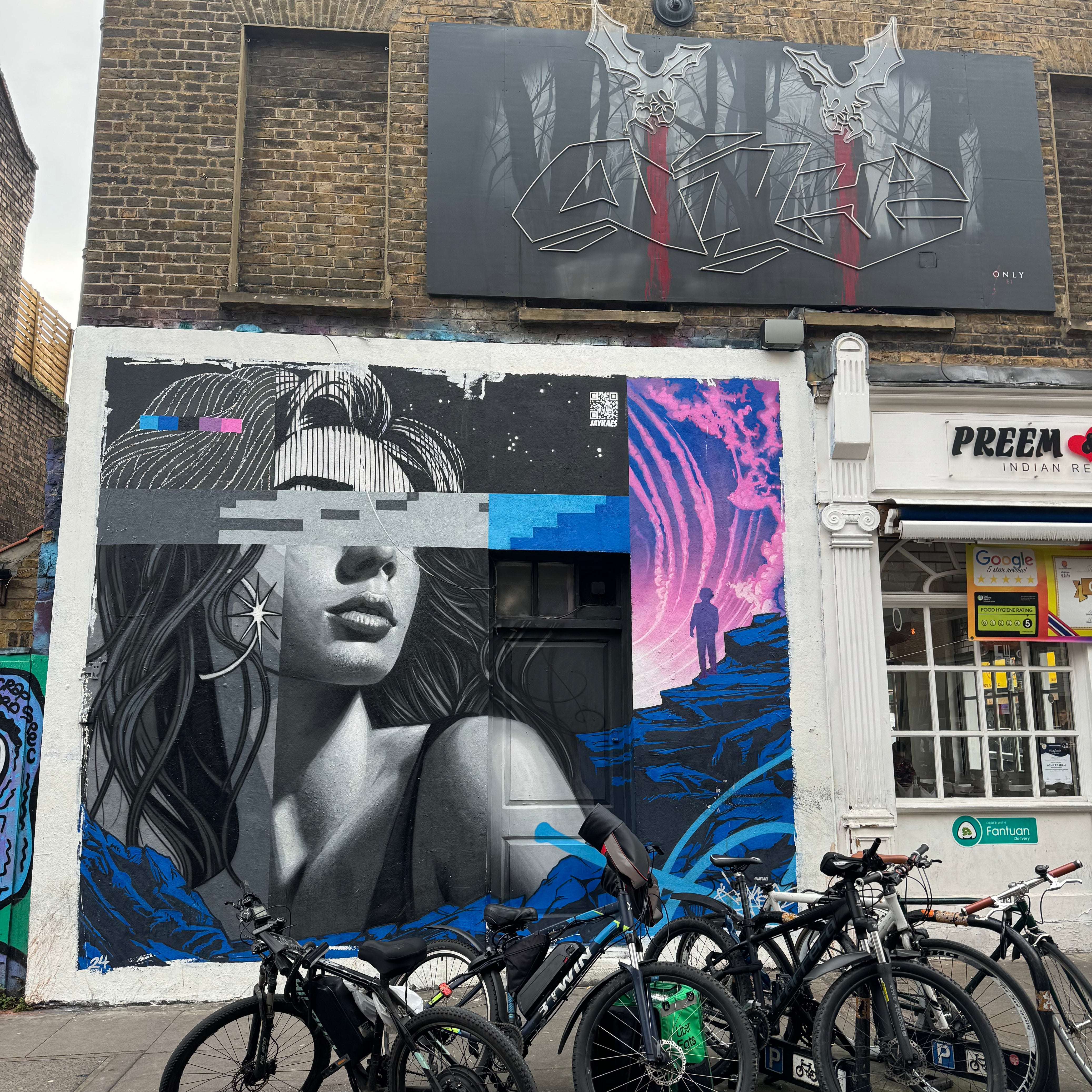 Friends exploring murals on Brick Lane during the Street Art Tour London