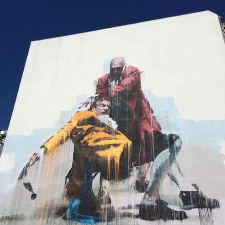 Coworkers photographing graffiti in Kødbyen during the Street Art Tour Copenhagen.