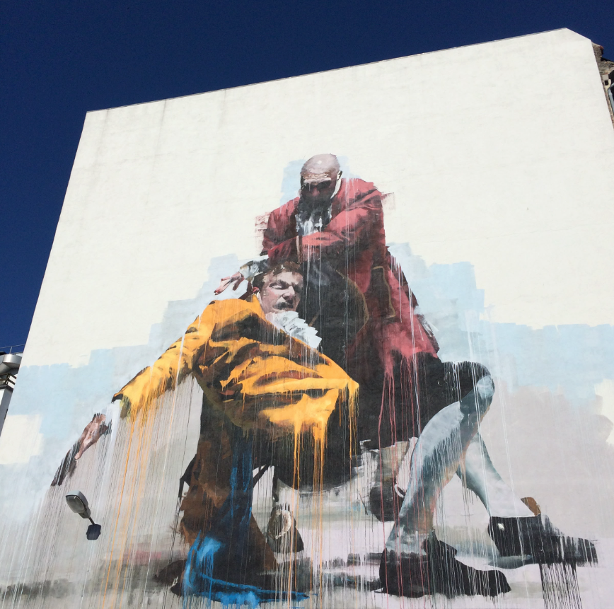 Coworkers photographing graffiti in Kødbyen during the Street Art Tour Copenhagen.