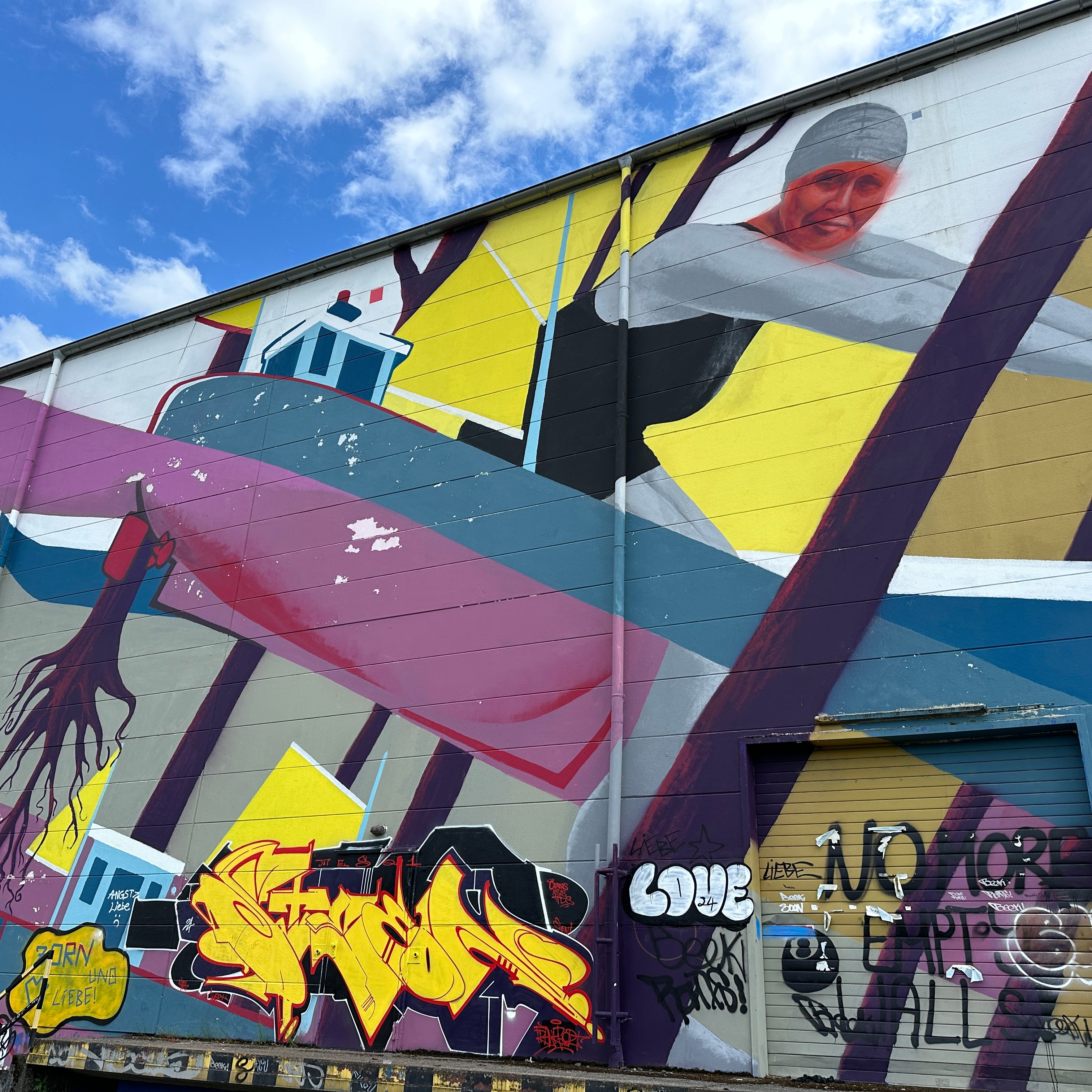 Textured shutter and color-block wall near Ostendstraße on the App-guided Street Art Tour Frankfurt
