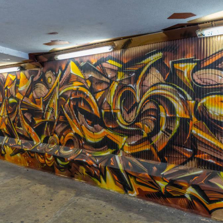 Team selfie by a bold wall at LX Factory during an Interactive Street Art Tour Lisbon