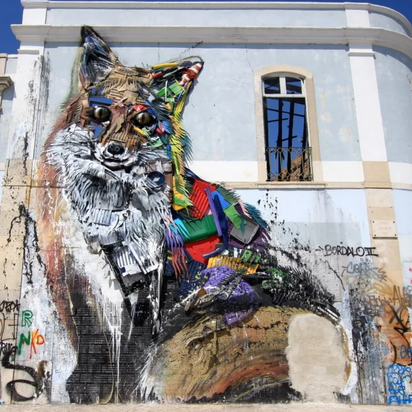Group checking the live leaderboard beside a Bordalo II “Trash Animal” in Lisbon