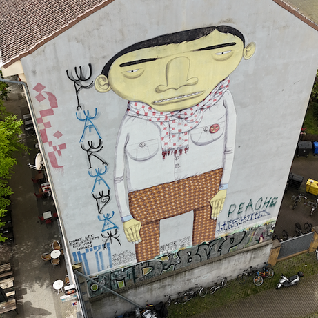Team exploring colorful murals during the Berlin Team Building Street Art Walk in Kreuzberg.
