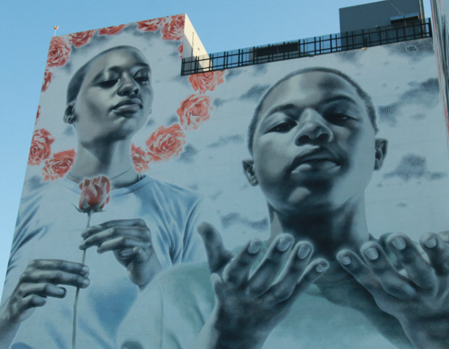 Shepard Fairey mural used as backdrop on an interactive street art tour in Miami