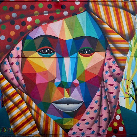 Sticker and poster layers in a Wynwood alley on the Street Art Tour Miami