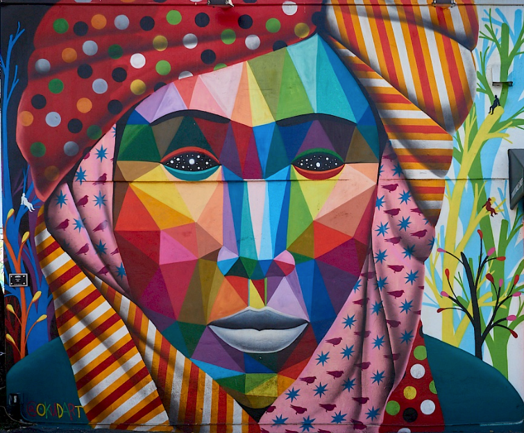 Sticker and poster layers in a Wynwood alley on the Street Art Tour Miami