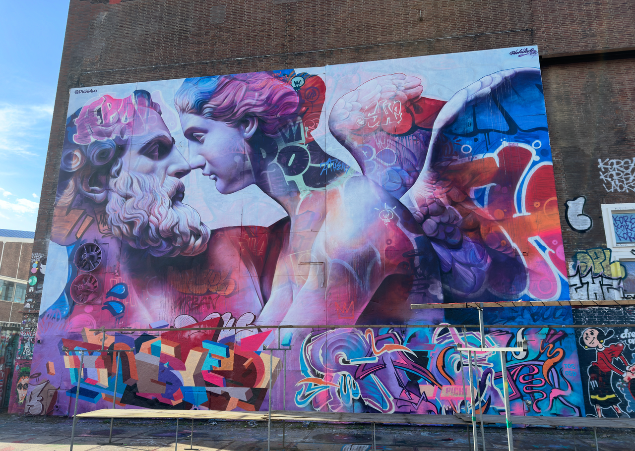 Friends exploring docks and murals at NDSM on the Street Art Tour Amsterdam