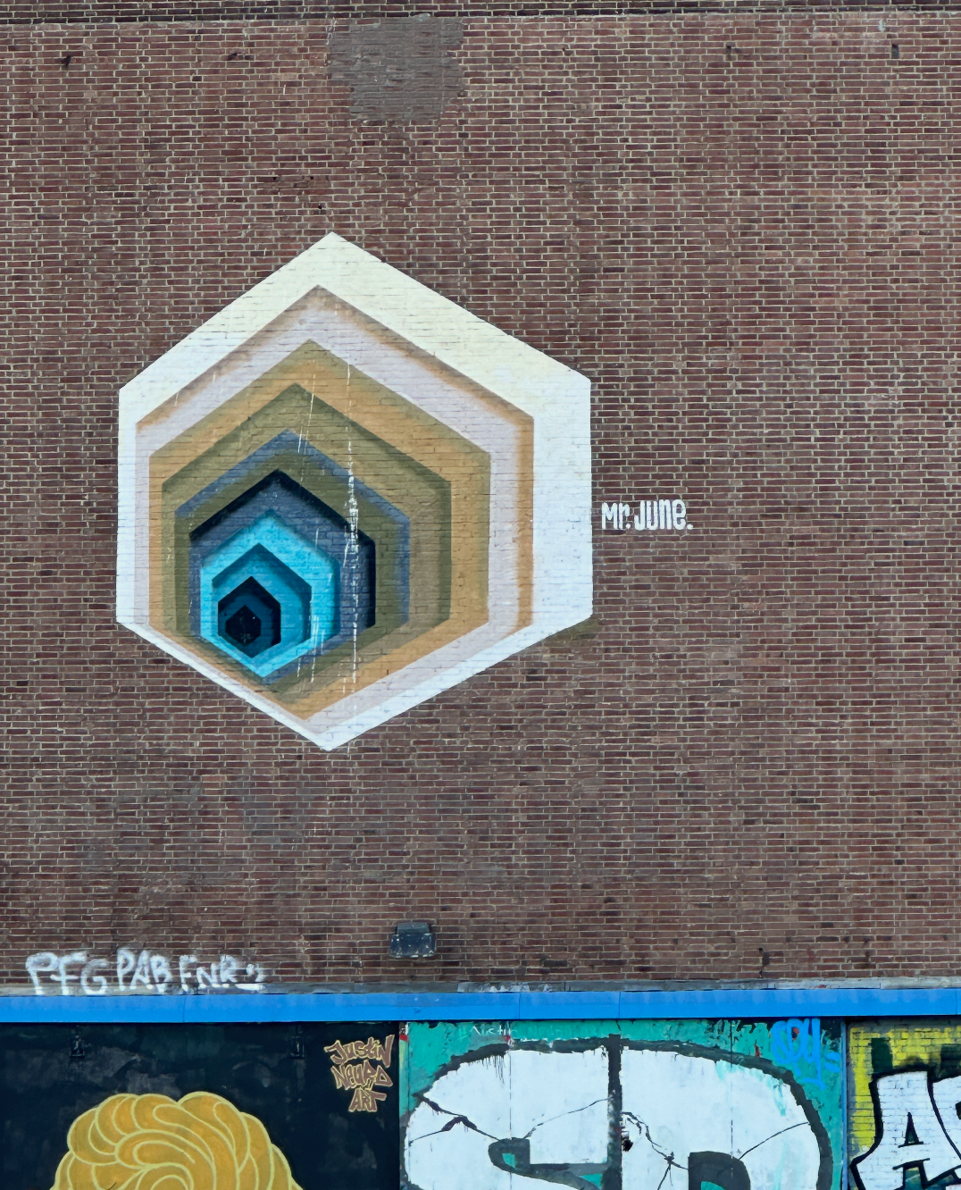 Group walking past geometric artworks by Mr. June on the Amsterdam Team Building Street Art Walk.