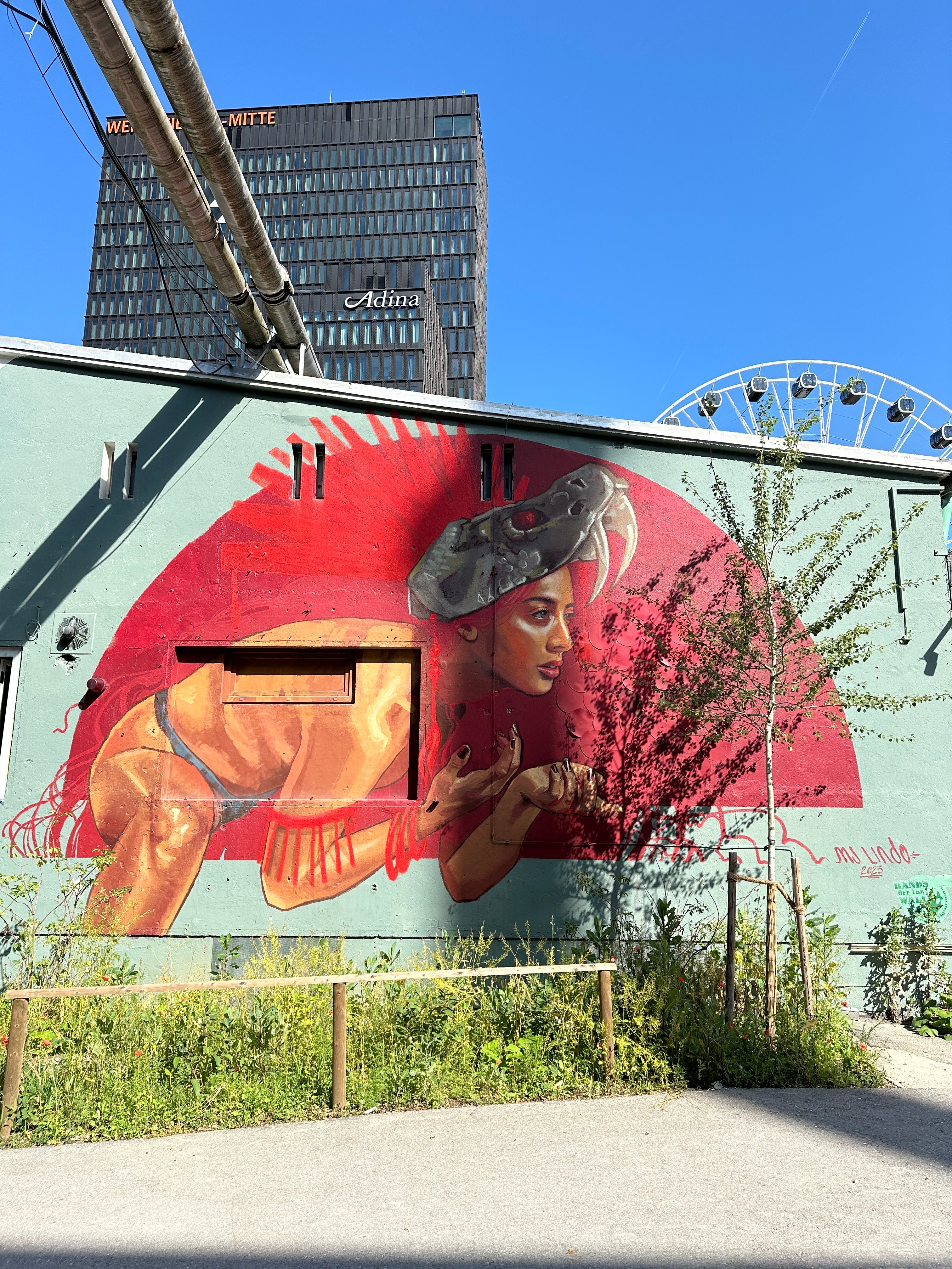 Creative team exploring hidden graffiti artworks during the Munich Team Building Street Art Walk.