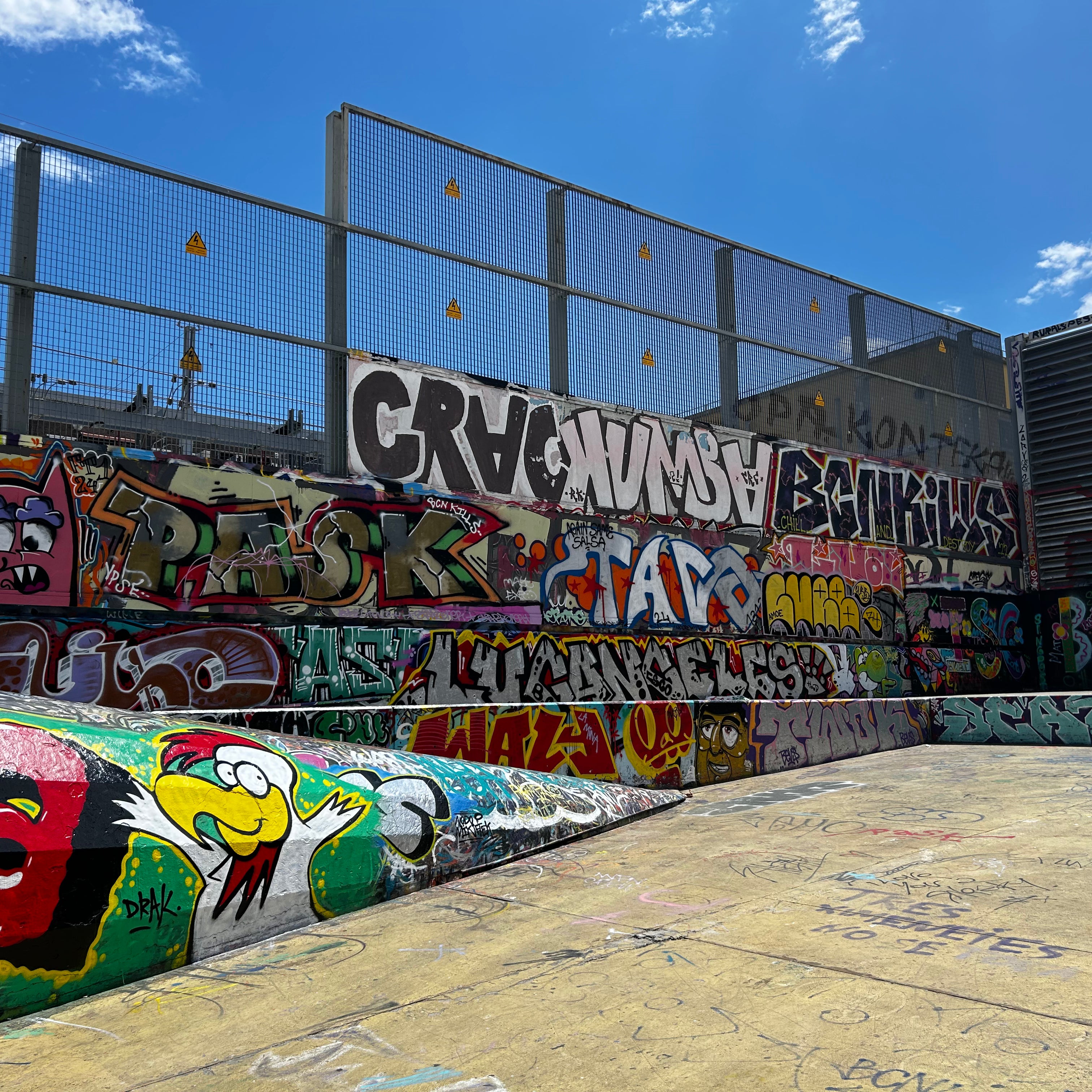 Creative coworkers posing in front of street art murals during the Barcelona Team Building Street Art Walk