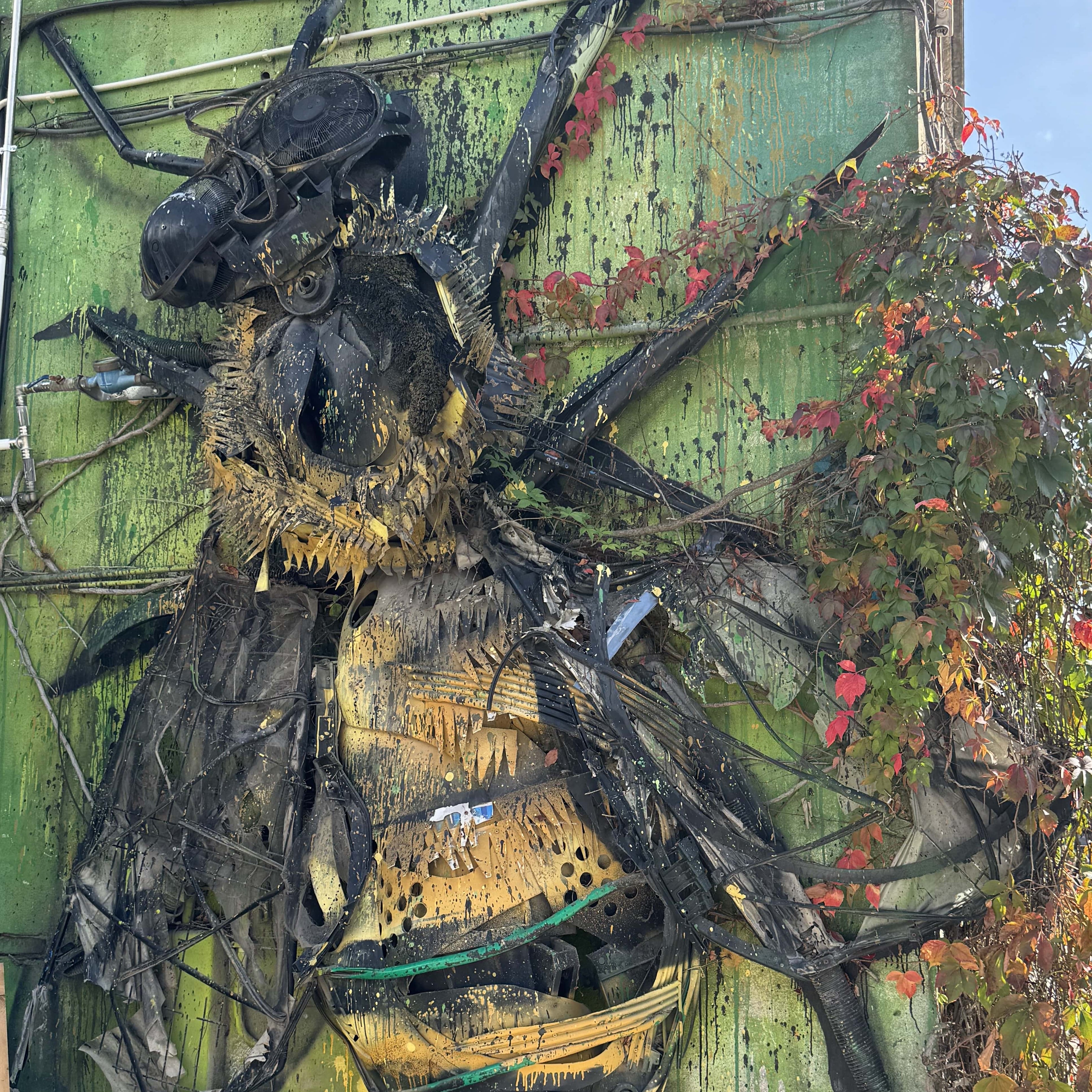Street Art Tour Lisbon featuring the 3D artwork Bee by Bordalo II, created from recycled plastic materials at the LX Factory in Lisbon.